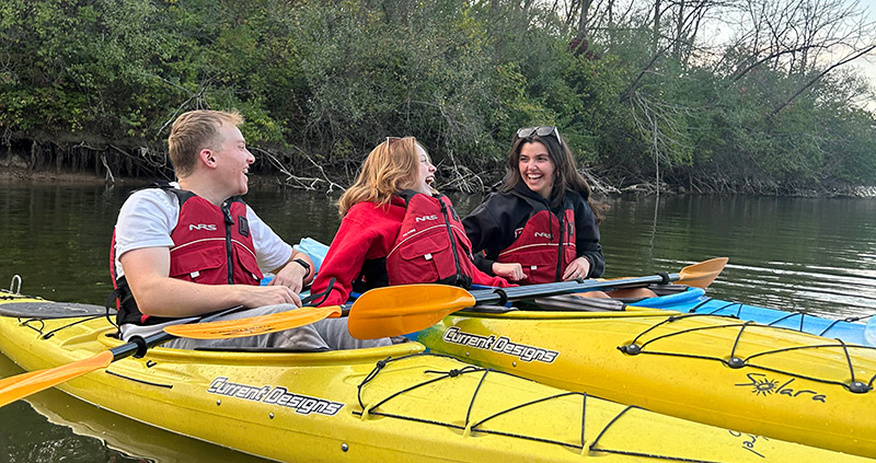 Three students on kayaks