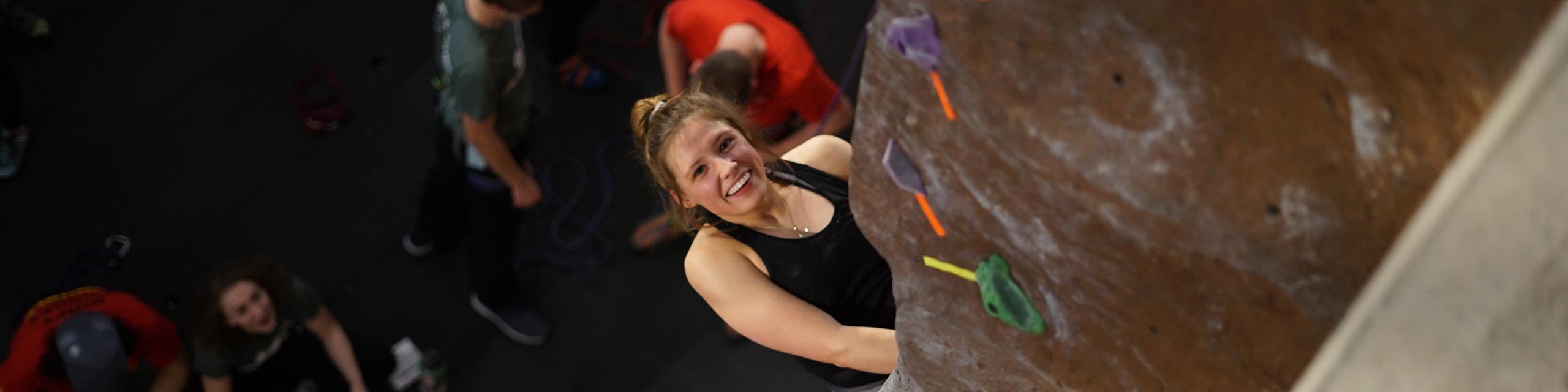 Student climbing the rock climbing wall.